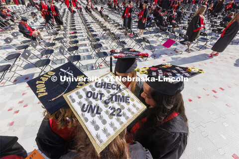 Decorated mortarboards at UNL undergraduate commencement in Memorial Stadium. May 14, 2022. 