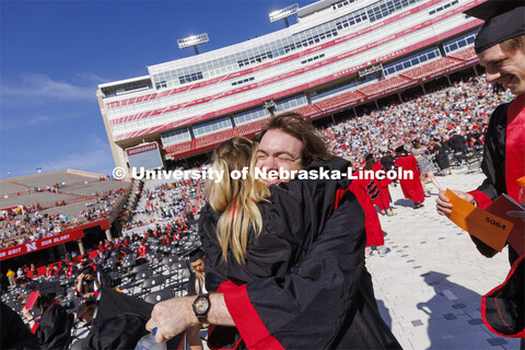 Mitchell Guynan hugs Megan Whisenhunt before commencement starts. UNL undergraduate commencement in 