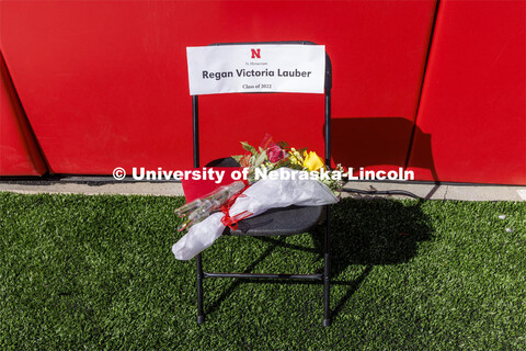 A chair with flowers and a program was in the corner of Memorial Stadium in honor of Regan Lauber wh