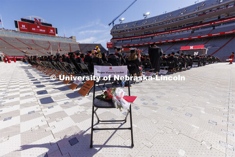 A chair with flowers and a program was in the corner of Memorial Stadium in honor of Regan Lauber wh