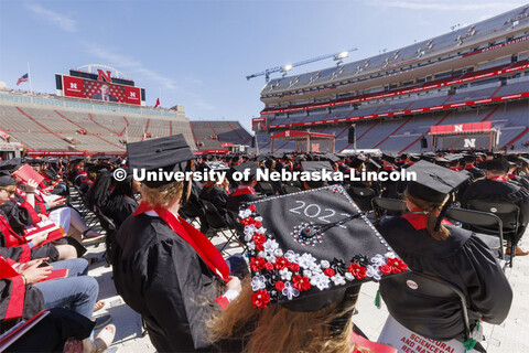 Decorated mortarboards at UNL undergraduate commencement in Memorial Stadium. May 14, 2022. 