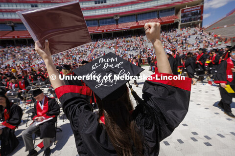 Skylar Hanson waves to her family as she returns to her seat with her diploma. UNL undergraduate com