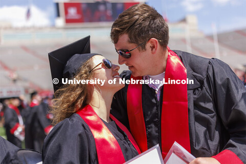 Maria Harthoorn and Jordan Popp share a kiss following commencement. Their summer plans are to marry