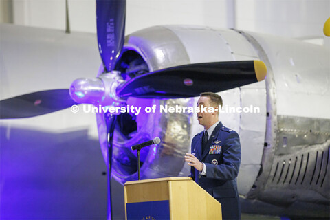 Lt. Col. C. J. Zaworski addresses the audience with a World War II era B-29 as a backdrop. The unive