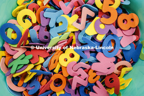 A bowl of colored foam letters and numbers at an art station. Guy Trainin’s project is Art TEAMS: 