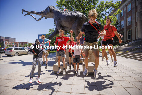 Students leap for joy in front of Archie. New student enrollment orientation and campus tours. June 