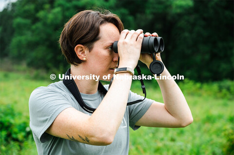 PhD Student Allison Barg looks and listens for different bird species while out checking acoustic mo