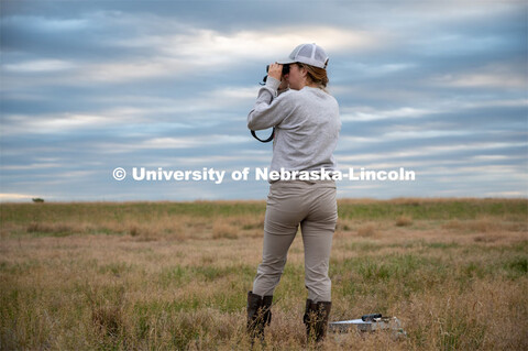 PhD student Grace Schuster looks and listens for different bird species during point counts, which a