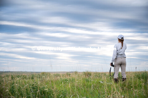 PhD student Grace Schuster looks and listens for different bird species during point counts, which a