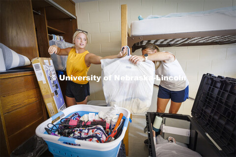 Katie Wemhoff from Grand Island grabs a handful of clothes from her mom, Cindy, as Katie unpacks her