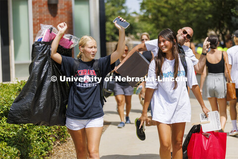 Stella Minge, left, let’s loose a yell as she and Lily Tobin, both of Omaha, head for their Schram