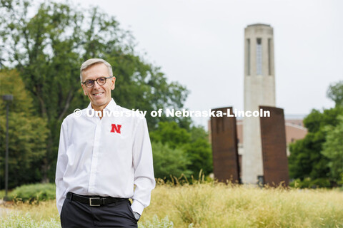 Chancellor Ronnie Green with the Mueller Bell Tower and Greenpoint sculpture in the background. Augu