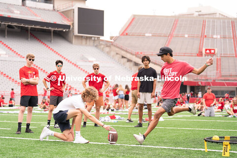 Husker fans play a game of football at the Nebraska vs Northwestern football watch party in Memorial