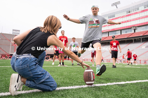 Husker fans play a game of football at the Nebraska vs Northwestern football watch party in Memorial