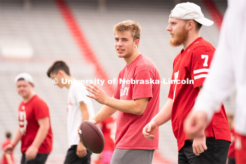 Husker fans play a game of football at the Nebraska vs Northwestern football watch party in Memorial