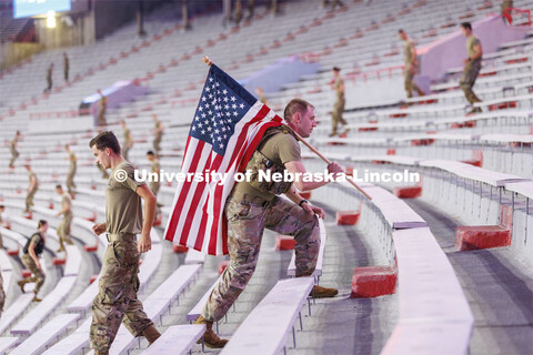 US Army Staff Sergeant Kyle Aldrich, a local recruiter, ran the steps carrying an American flag. Mor