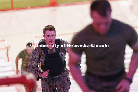Midshipman Cohan Banow runs the east stadium steps. More than 160 UNL ROTC cadets along with active-