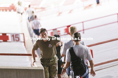 An Air Force ROTC cadet fist bumps another for encouragement during the run. More than 160 UNL ROTC 