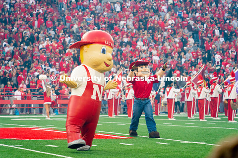 Lil' Red and Herbie Husker on the field at the Nebraska vs. Georgia Southern football in Memorial St