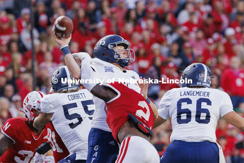 Nebraska football players work to defeat Georgia Southern. Nebraska vs. Georgia Southern football in