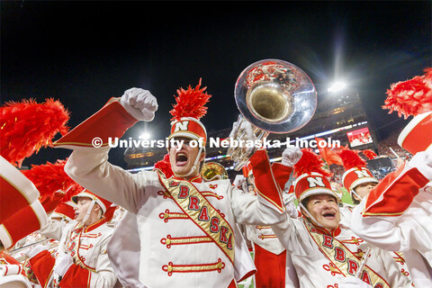 Nate Hollenbeck, a baritone in the Cornhusker Marching Band, fires up the crowd with the rest of the