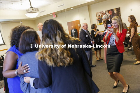 Graduate Assistant Christa Rahl photographs attendees at the celebration. Celebration for 30th anniv