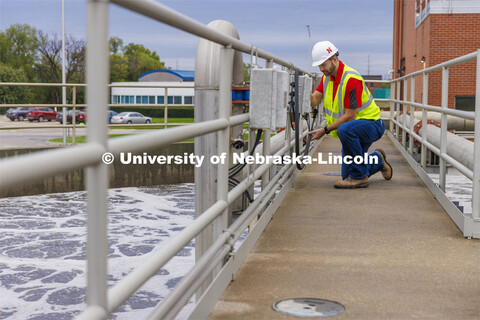 Andrew Hansen, graduate student in Environmental Engineering, looks over a control box for a sedimen