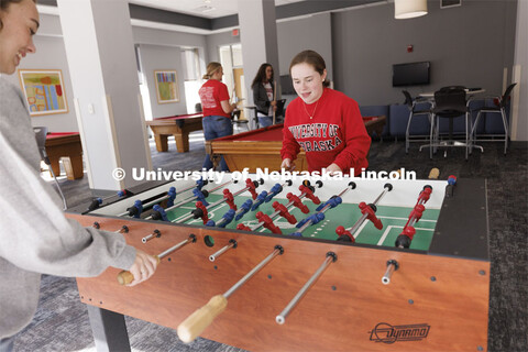 Students playing foosball. Housing Photo Shoot in Able Sandoz Residence Hall. September 27, 2022. 