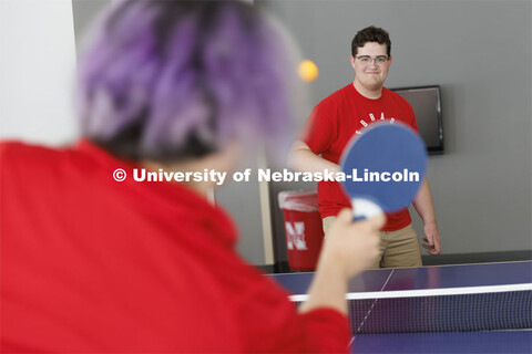 Students playing a game of ping-pong. Housing Photo Shoot in Able Sandoz Residence Hall. September 2