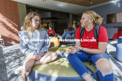 Student socializing in a commons area. Housing Photo Shoot in Able Sandoz Residence Hall. September 