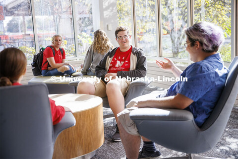 Student socializing in a commons area. Housing Photo Shoot in Able Sandoz Residence Hall. September 