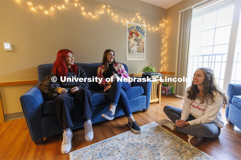 Students socializing in an apartment style room in The Courtyards Residence Hall. Housing Photo Shoo