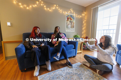 Students socializing in an apartment style room in The Courtyards Residence Hall. Housing Photo Shoo