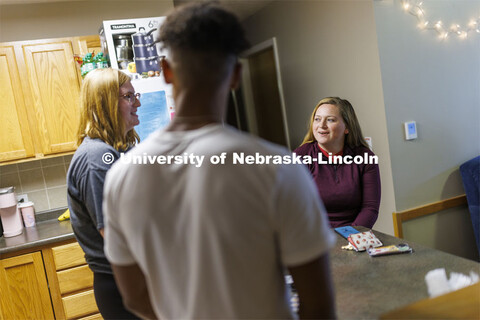 Students socializing in an apartment style room in The Courtyards Residence Hall. Housing Photo Shoo