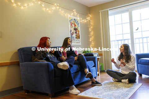 Students socializing in an apartment style room in The Courtyards Residence Hall. Housing Photo Shoo