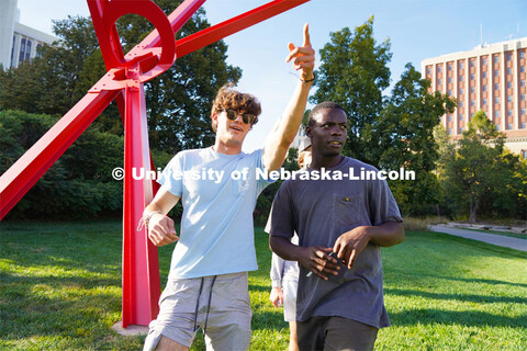 Kappa Sigma Fraternity member points to his fraternity brother where the next location in their race