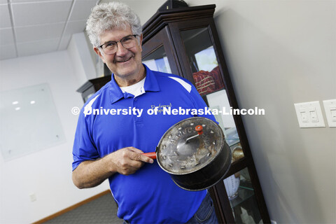Norm Krug proudly shows his grandfather’s popcorn popper. The popper resides in a case in the comp