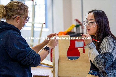 Students Elizabeth Loftus (left) and Caroline Gomel (right) begin assembly of their plant stand. Arc