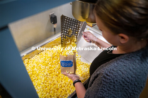 Freshman Emma Georgia helps prepare popcorn for moviegoers at the Ross Theater November 9, 2022. 