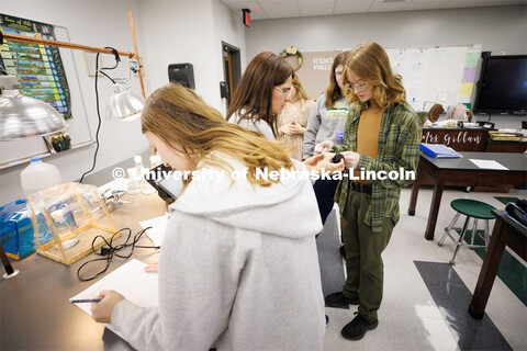 Chelle Gillan helps Kit Brooks compare values on urine samples as Sara Musil records the data. Frida