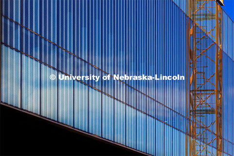 The construction crane tower is reflected in the patterned window glass of Kiewit Hall. November 22,