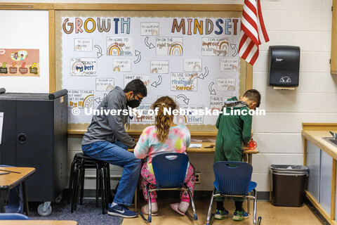Rohan Tatineni helps two students build their cars. Nebraska honors students Spencer Knight (blue sh