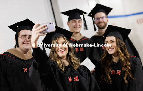 Morgan Erwin takes a selfie with fellow College of Business masters graduates. Graduate Commencement