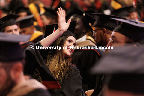 Tara Asgarpoor waves to family and friends before the Graduate Commencement in Pinnacle Bank Arena. 