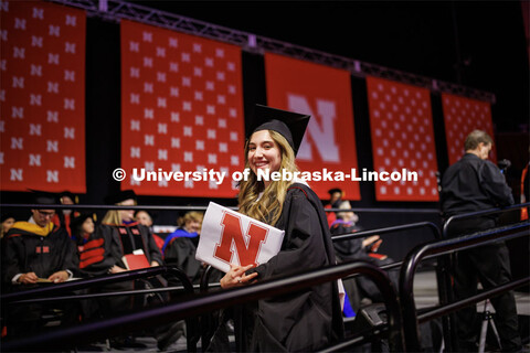 Margarita Shmakova walks offstage after receiving her masters degree in Journalism and Mass Communic