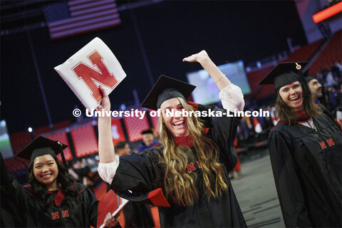 Erika Dreifurst celebrates here masters degree during the recessional. Graduate Commencement in Pinn