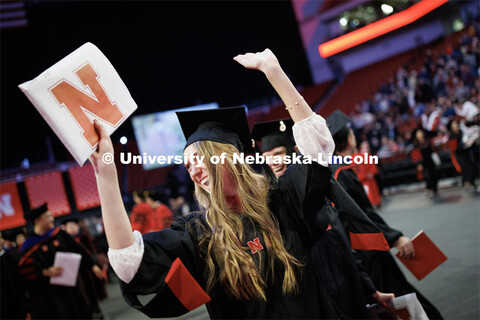 Erika Dreifurst celebrates here masters degree during the recessional. Graduate Commencement in Pinn