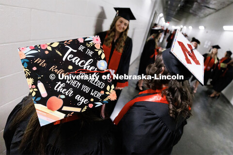 Education graduates Julia Raffel, left, and Alexis Goodenberger wear their decorated mortar boards. 