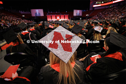 Valerie Powers’ decorated mortar board sparkles under the arena lights. Winter Undergraduate Comme