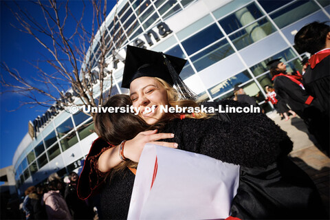 Marissa Heimes, a graduate in Nutritional Science and Dietetics, hugs a friend following commencemen